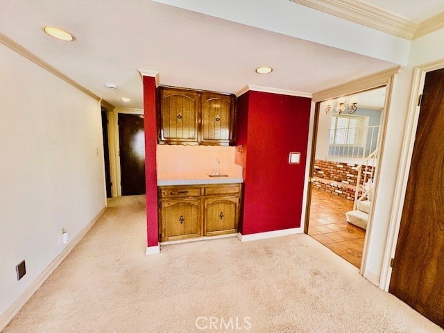 30417 Golden Gate Dr, Canyon Lake, CA 92587 - kitchen with ornamental molding, light colored carpet, recessed lighting, tile countertops, and brown cabinets