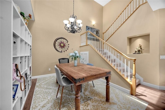 23985 Nicole Way, Yorba Linda, CA 92887 - dining space with a high ceiling, stairway, a chandelier, baseboards, and wood finished floors