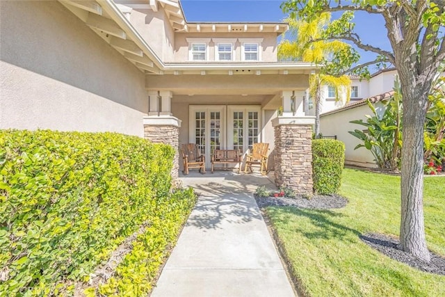 26808 Lemon Grass Way, Murrieta, CA 92562 - doorway to property with stucco siding, covered porch, a yard, french doors, and stone siding