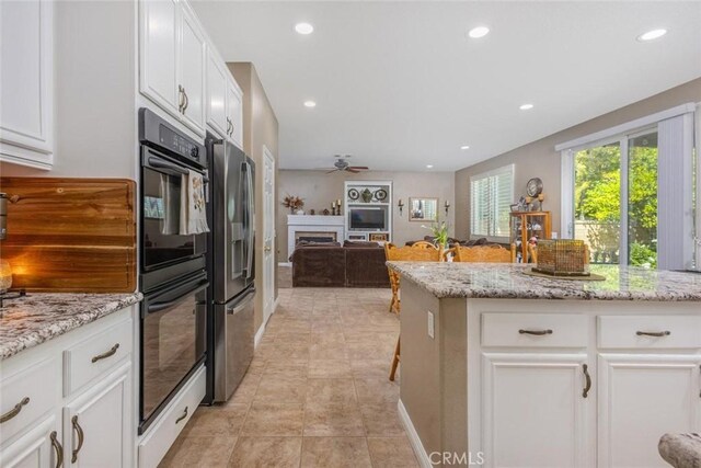 26808 Lemon Grass Way, Murrieta, CA 92562 - kitchen with stainless steel fridge with ice dispenser, recessed lighting, white cabinets, a fireplace, and a ceiling fan