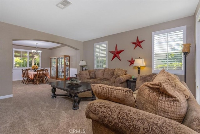 26808 Lemon Grass Way, Murrieta, CA 92562 - living area with arched walkways, a chandelier, plenty of natural light, and carpet flooring