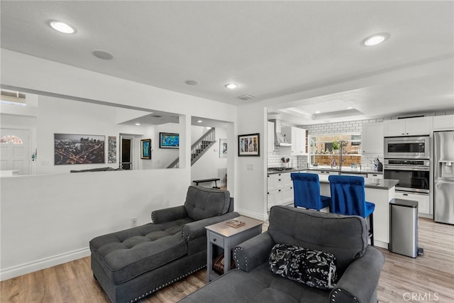 19777 Azure Field Dr, Newhall, CA 91321 - living area with light wood-style floors, stairs, recessed lighting, and baseboards