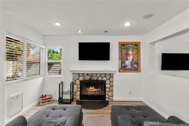 19777 Azure Field Dr, Newhall, CA 91321 - living area with wood finished floors, a stone fireplace, and recessed lighting