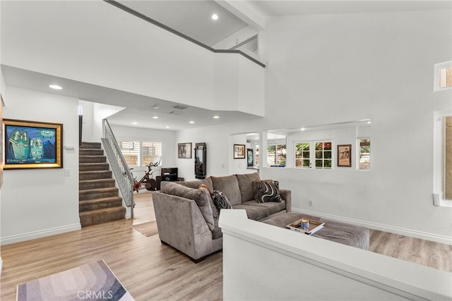 19777 Azure Field Dr, Newhall, CA 91321 - living area with light wood-style flooring, beamed ceiling, stairway, baseboards, and high vaulted ceiling