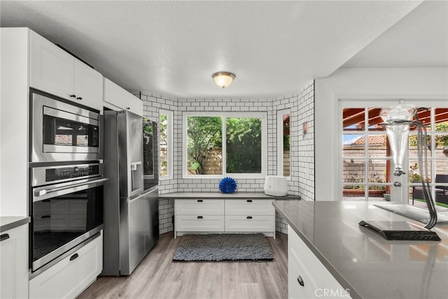 19777 Azure Field Dr, Newhall, CA 91321 - kitchen with appliances with stainless steel finishes, healthy amount of natural light, and light wood-type flooring