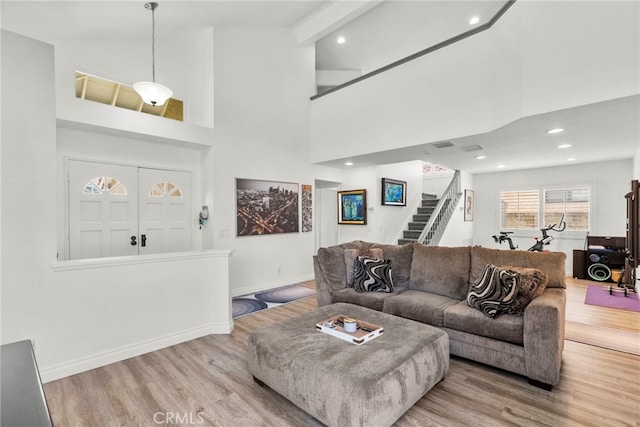 19777 Azure Field Dr, Newhall, CA 91321 - living area featuring stairs, wood finished floors, baseboards, recessed lighting, and a high ceiling