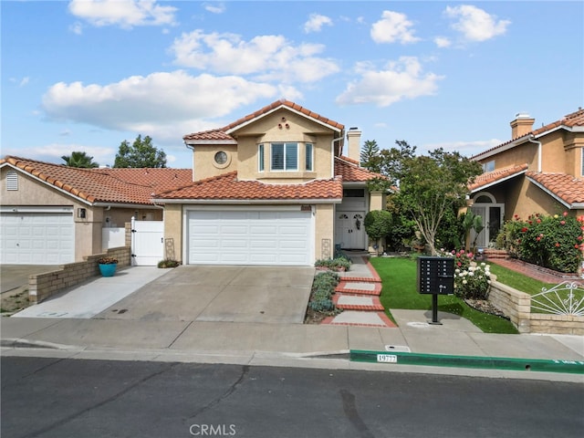 19777 Azure Field Dr, Newhall, CA 91321 - mediterranean / spanish house with a tile roof, a gate, driveway, stucco siding, and a garage
