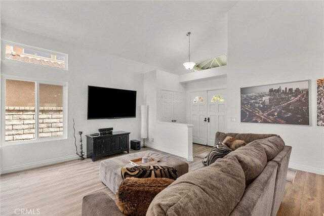 19777 Azure Field Dr, Newhall, CA 91321 - living area featuring high vaulted ceiling, light wood-style floors, and healthy amount of natural light