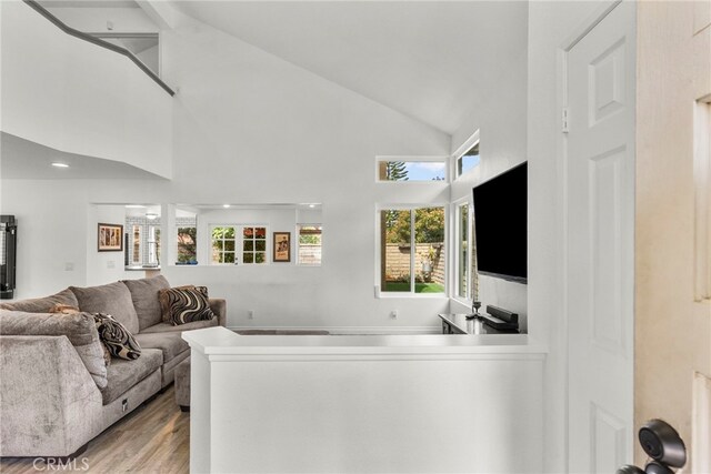 19777 Azure Field Dr, Newhall, CA 91321 - living area featuring light wood-style floors, healthy amount of natural light, and high vaulted ceiling
