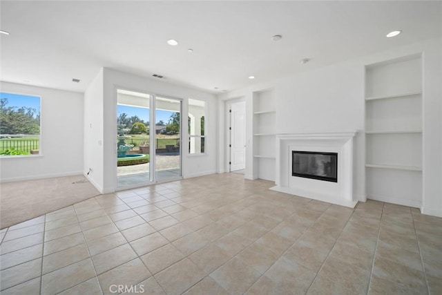 1824 Nathan Way, Nipomo, CA 93444 - unfurnished living room featuring built in shelves, baseboards, light tile patterned flooring, a glass covered fireplace, and recessed lighting
