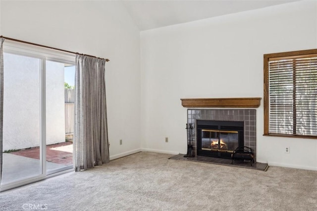 10710 El Camino Real Unit 17, Atascadero, CA 93422 - unfurnished living room featuring carpet, a fireplace, high vaulted ceiling, and baseboards
