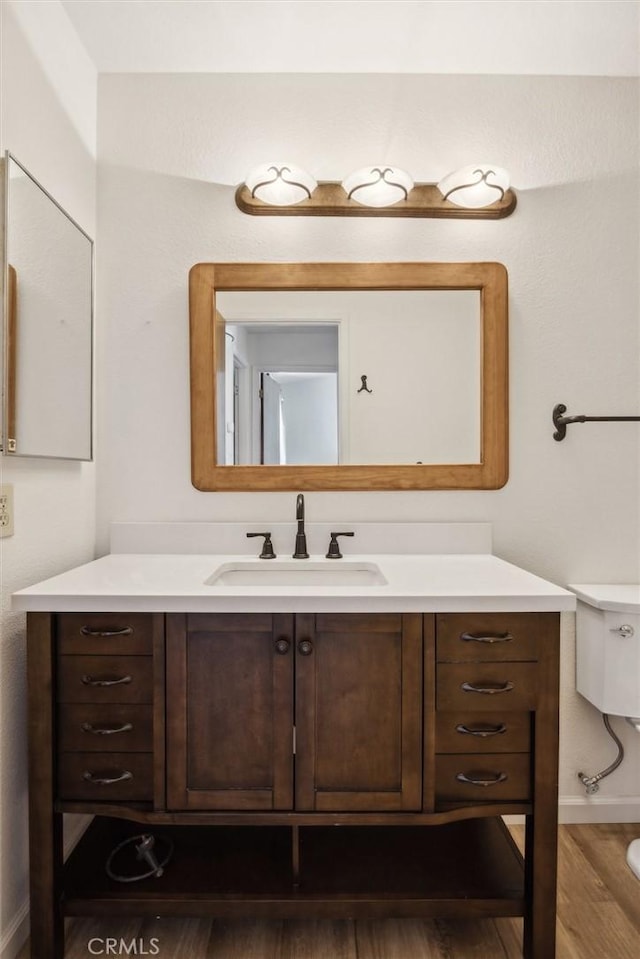 10710 El Camino Real Unit 17, Atascadero, CA 93422 - bathroom featuring vanity, wood finished floors, baseboards, and toilet