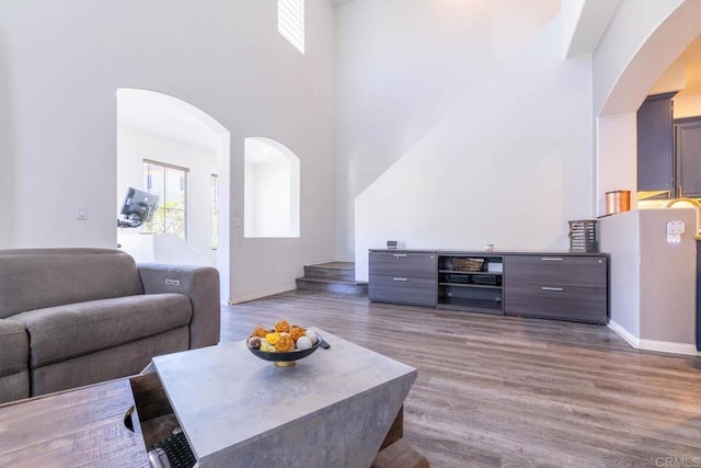 2772 Piantino Cir, San Diego, CA 92108 - living room with arched walkways, wood finished floors, a towering ceiling, and baseboards