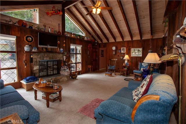 31510 Overhill Dr, Running Springs, CA 92382 - living area with wood walls, carpet, a stone fireplace, high vaulted ceiling, and wood ceiling with exposed beams