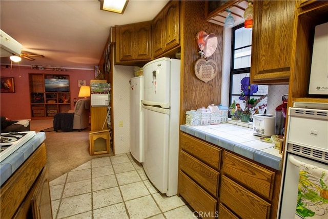 31510 Overhill Dr, Running Springs, CA 92382 - kitchen with white appliances, brown cabinets, open floor plan, and tile countertops