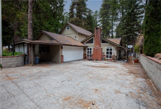 31510 Overhill Dr, Running Springs, CA 92382 - view of front facade with a chimney, an attached garage, and driveway