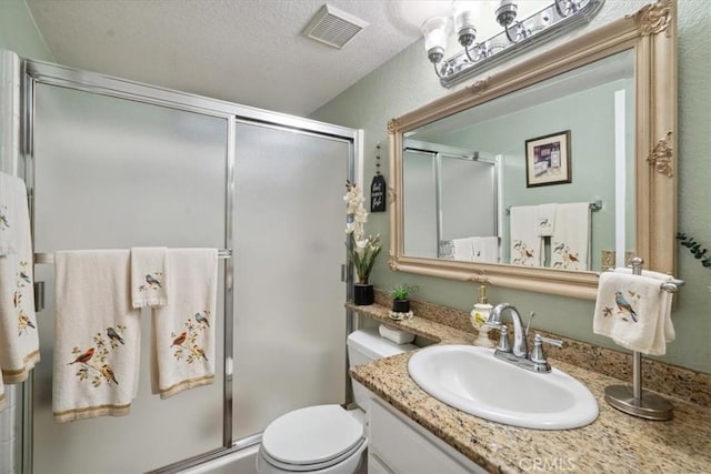 29159 Palm View Ln, Highland, CA 92346 - bathroom featuring vanity, a shower with door, toilet, and a textured ceiling