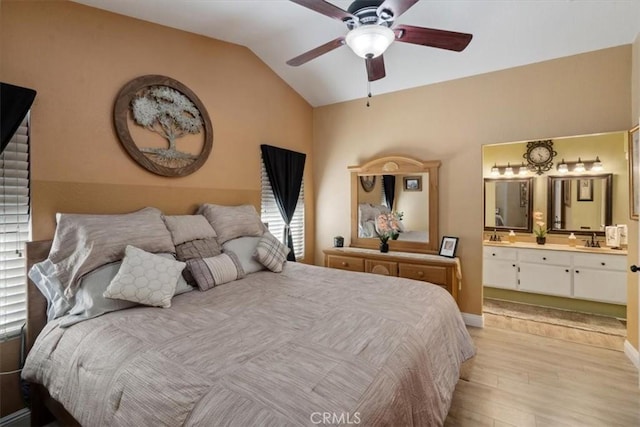 29159 Palm View Ln, Highland, CA 92346 - bedroom featuring light wood-style floors, vaulted ceiling, connected bathroom, a sink, and baseboards