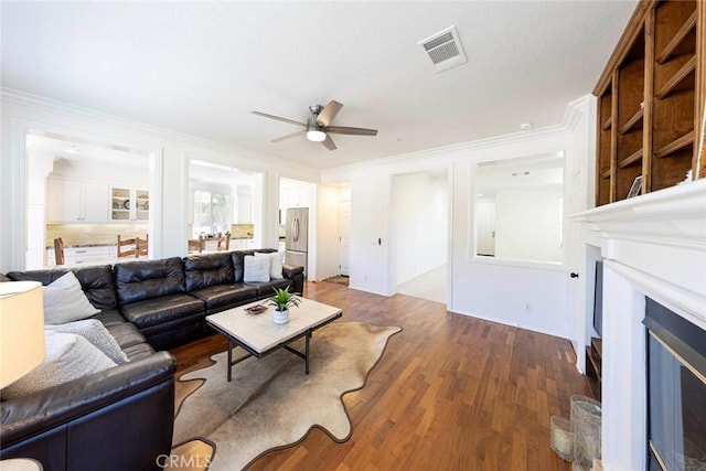 6121 Camino Forestal, San Clemente, CA 92673 - living area featuring a ceiling fan, a glass covered fireplace, ornamental molding, and wood finished floors