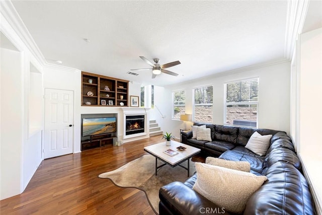 6121 Camino Forestal, San Clemente, CA 92673 - living room featuring wood finished floors, a glass covered fireplace, ornamental molding, and a ceiling fan