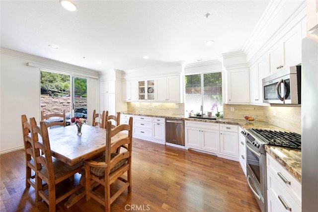 6121 Camino Forestal, San Clemente, CA 92673 - kitchen with appliances with stainless steel finishes, plenty of natural light, decorative backsplash, white cabinetry, and ornamental molding