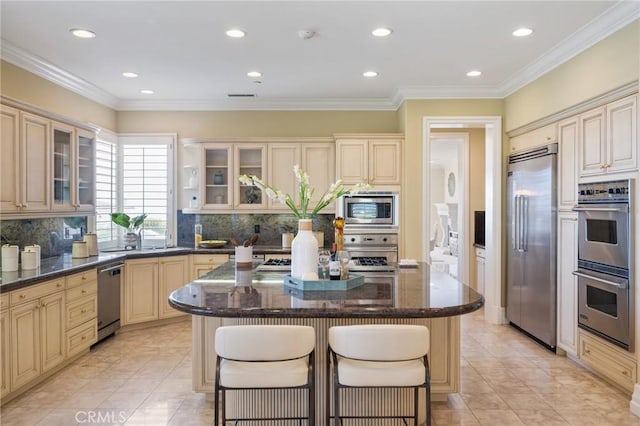 20 Via Del Cielo, Rancho Palos Verdes, CA 90275 - kitchen featuring built in appliances, cream cabinets, a center island, a kitchen bar, and tasteful backsplash