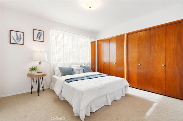 538 Palisades Ave, Santa Monica, CA 90402 - bedroom with light carpet, two closets, and baseboards