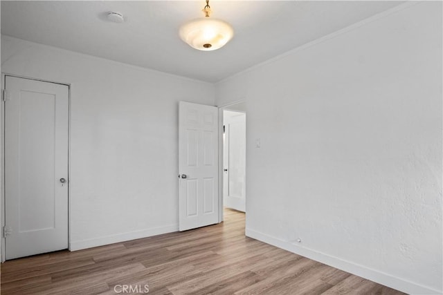 26021 President Ave, Harbor City, CA 90710 - unfurnished bedroom featuring wood finished floors, crown molding, and baseboards