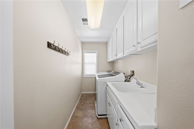 23650 Kathryn St, Murrieta, CA 92562 - laundry area with cabinet space, washing machine and dryer, baseboards, and stone finish flooring