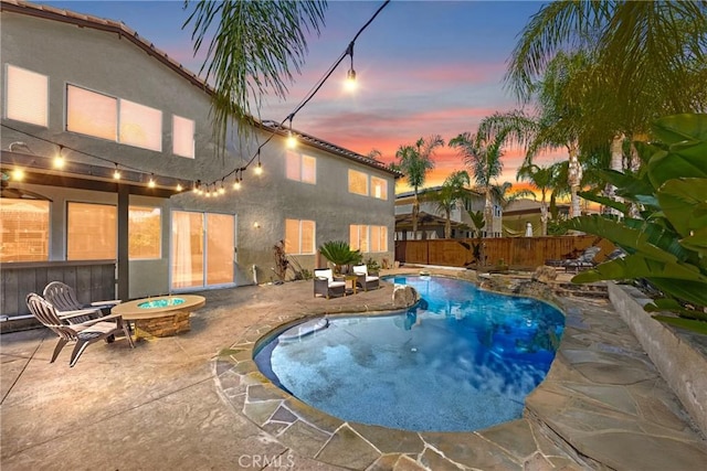 23650 Kathryn St, Murrieta, CA 92562 - pool at dusk featuring a fire pit, a patio, and a fenced backyard