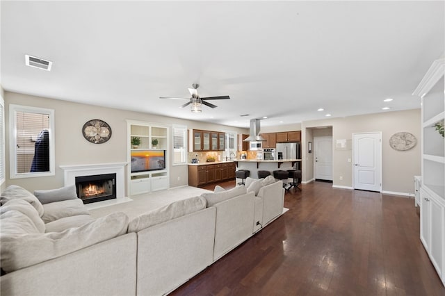 23650 Kathryn St, Murrieta, CA 92562 - living area with recessed lighting, a lit fireplace, dark wood-type flooring, ceiling fan, and baseboards