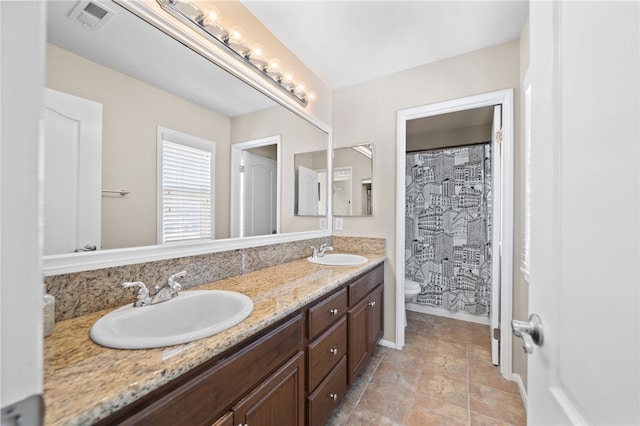 23650 Kathryn St, Murrieta, CA 92562 - bathroom featuring toilet, double vanity, a shower with shower curtain, baseboards, and stone finish flooring