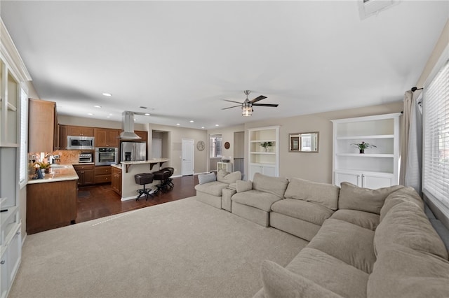 23650 Kathryn St, Murrieta, CA 92562 - living area with recessed lighting, ceiling fan, dark wood-style flooring, and dark carpet