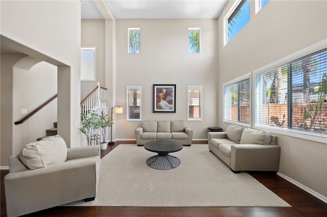 23650 Kathryn St, Murrieta, CA 92562 - living room with a towering ceiling, dark wood finished floors, stairway, and baseboards
