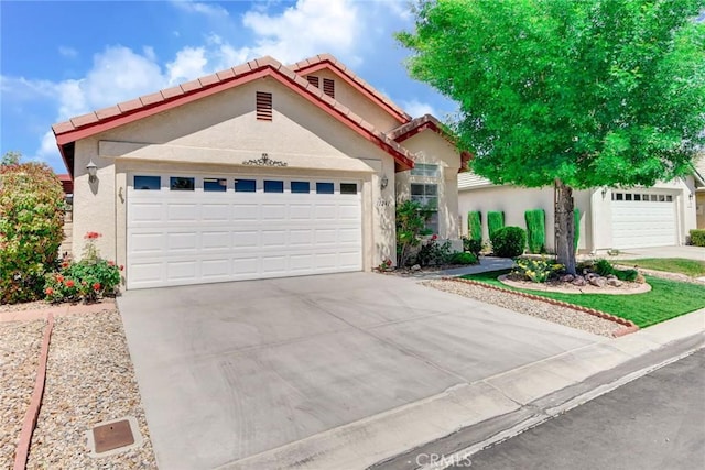 11241 Pleasant Hills Dr, Apple Valley, CA 92308 - view of front of house with concrete driveway, stucco siding, an attached garage, and a tiled roof