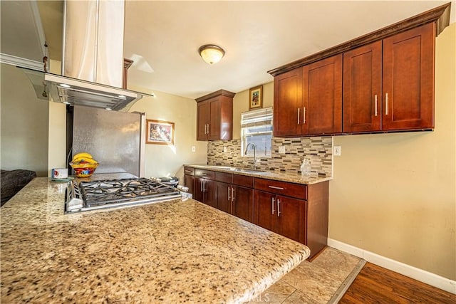 1915 E 55th St, Long Beach, CA 90805 - kitchen featuring island exhaust hood, baseboards, a sink, wood finished floors, and decorative backsplash