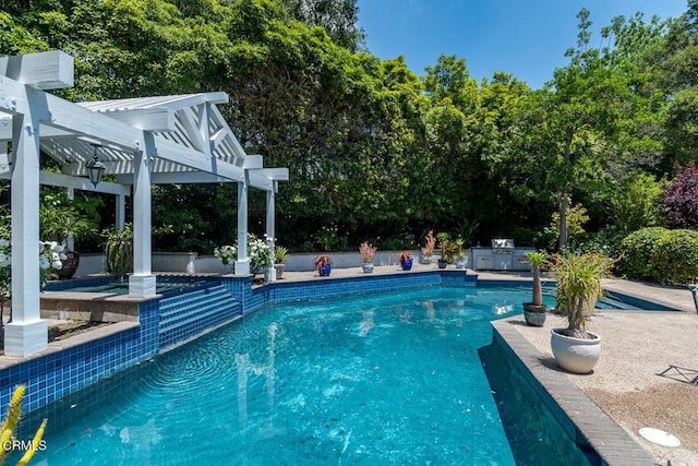 4409 Encinas Dr, La Canada Flintridge, CA 91011 - outdoor pool featuring a pergola, view of wooded area, and exterior kitchen