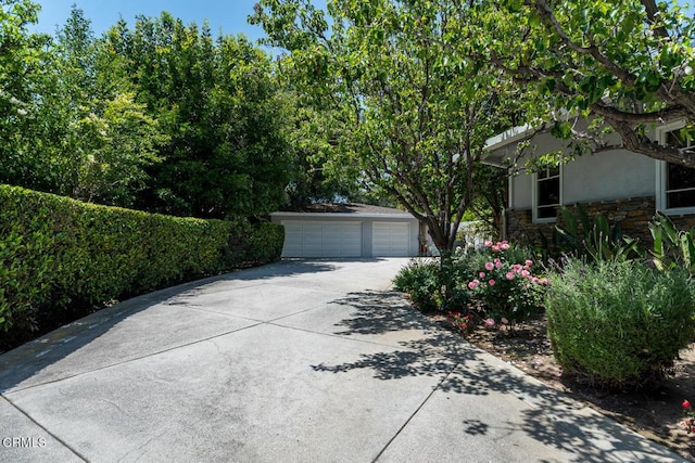 4409 Encinas Dr, La Canada Flintridge, CA 91011 - view of front facade with stone siding, a detached garage, and stucco siding