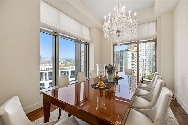 10776 Wilshire Blvd Unit 901, Los Angeles, CA 90024 - dining space with baseboards, a city view, and a chandelier