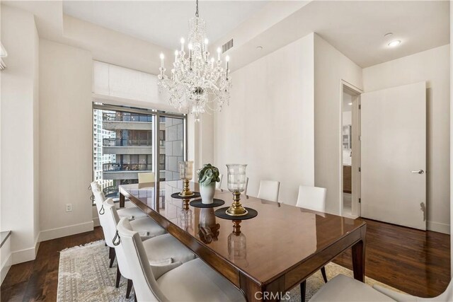10776 Wilshire Blvd Unit 901, Los Angeles, CA 90024 - dining area with a chandelier, dark wood-style floors, and baseboards