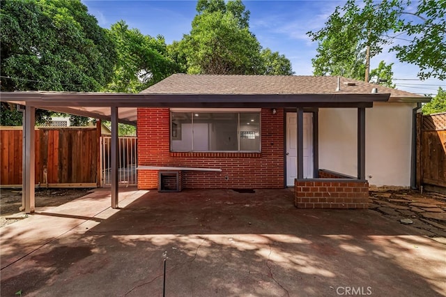 178 E Washington Ave, Chico, CA 95926 - view of front of property featuring roof with shingles, brick siding, and a carport