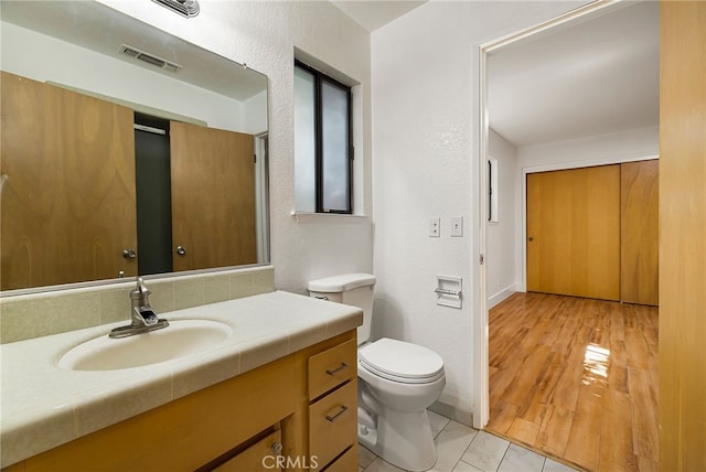 178 E Washington Ave, Chico, CA 95926 - bathroom featuring vanity, toilet, a textured wall, baseboards, and tile patterned floors