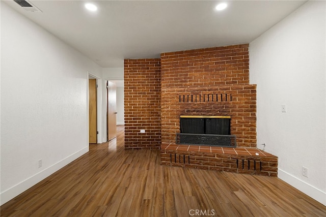 178 E Washington Ave, Chico, CA 95926 - unfurnished living room with a brick fireplace, wood finished floors, baseboards, and recessed lighting