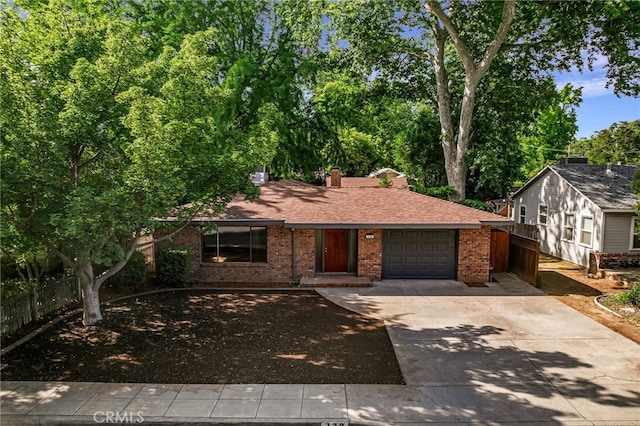 178 E Washington Ave, Chico, CA 95926 - view of front of home with brick siding, driveway, an attached garage, and roof with shingles