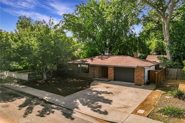 178 E Washington Ave, Chico, CA 95926 - view of front of house with an attached garage, a chimney, brick siding, and driveway