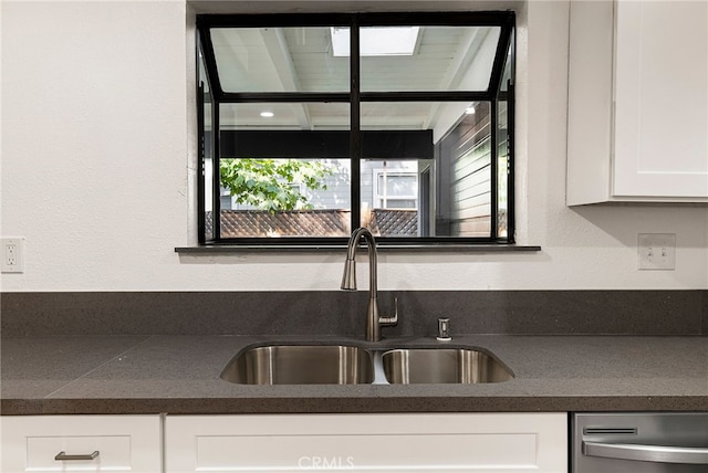 178 E Washington Ave, Chico, CA 95926 - kitchen with a sink, dark countertops, dishwasher, and white cabinets