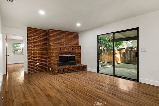 178 E Washington Ave, Chico, CA 95926 - unfurnished living room with wood finished floors, plenty of natural light, baseboards, a fireplace, and recessed lighting