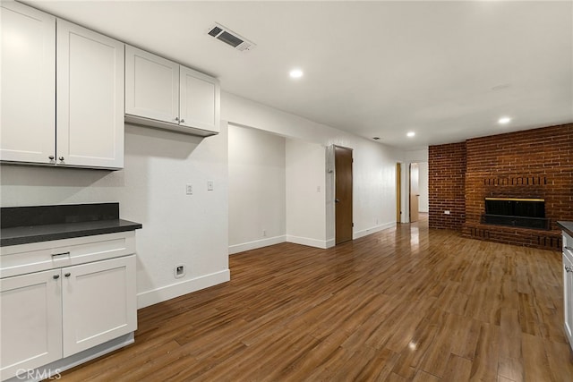 178 E Washington Ave, Chico, CA 95926 - unfurnished living room with baseboards, wood finished floors, a fireplace, and recessed lighting