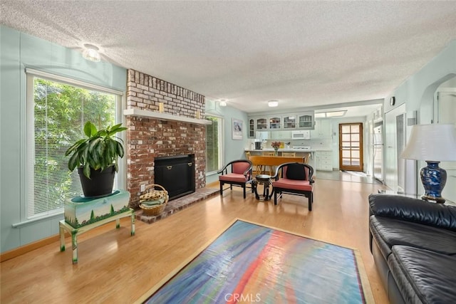 243 N 11th St, Grover Beach, CA 93433 - living area featuring a textured ceiling, wood finished floors, and a fireplace