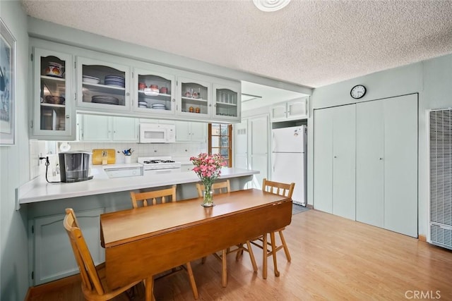 243 N 11th St, Grover Beach, CA 93433 - dining area featuring a heating unit, a textured ceiling, and light wood-type flooring